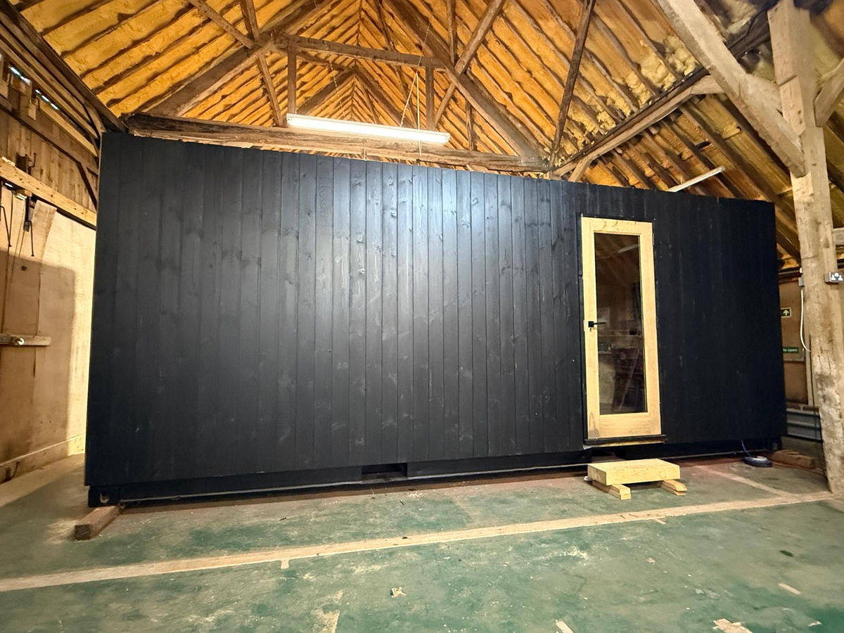 Corva exterior — charred timber cladding, finished in black