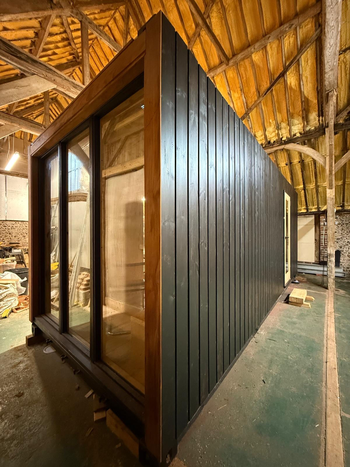 Corva exterior — corner detail in cedar and blackened timber